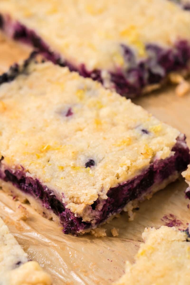 sliced blueberry pie bars on parchment