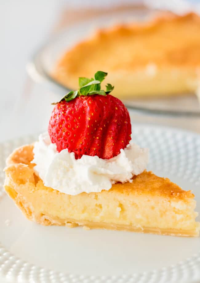 slice of buttermilk pie with strawberries and cream