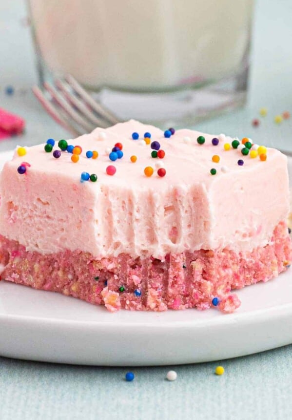 up close slice of no bake circus cookie cheesecake