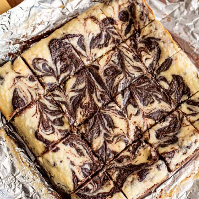 sliced cream cheese brownies on foil