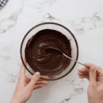 melted chocolate in a glass bowl with a spoon.