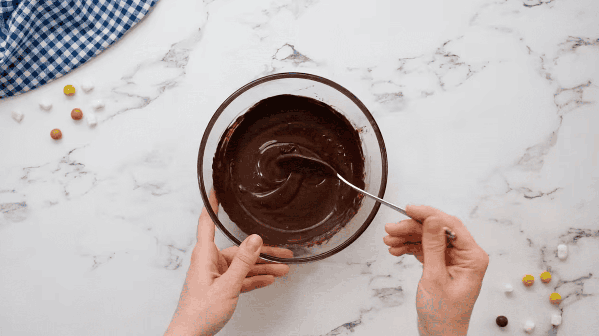 melted chocolate in a glass bowl with a spoon.