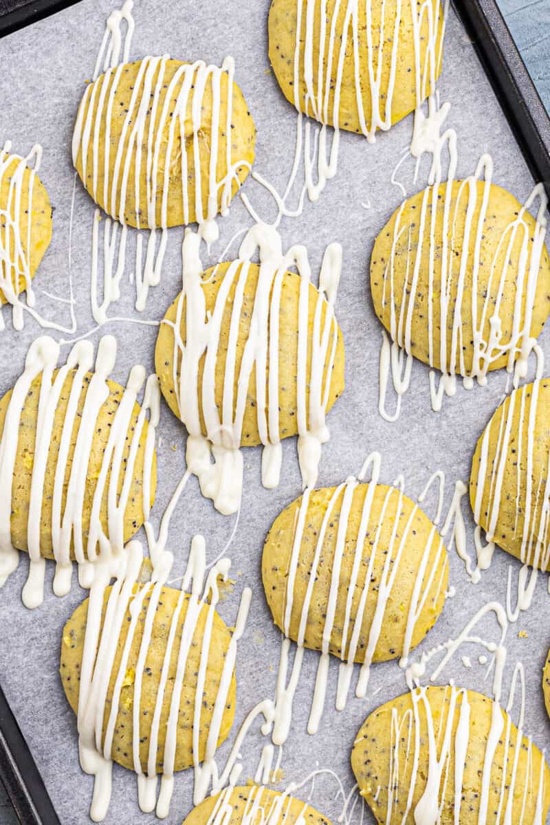 drizzled lemon poppy seed cookies on parchment