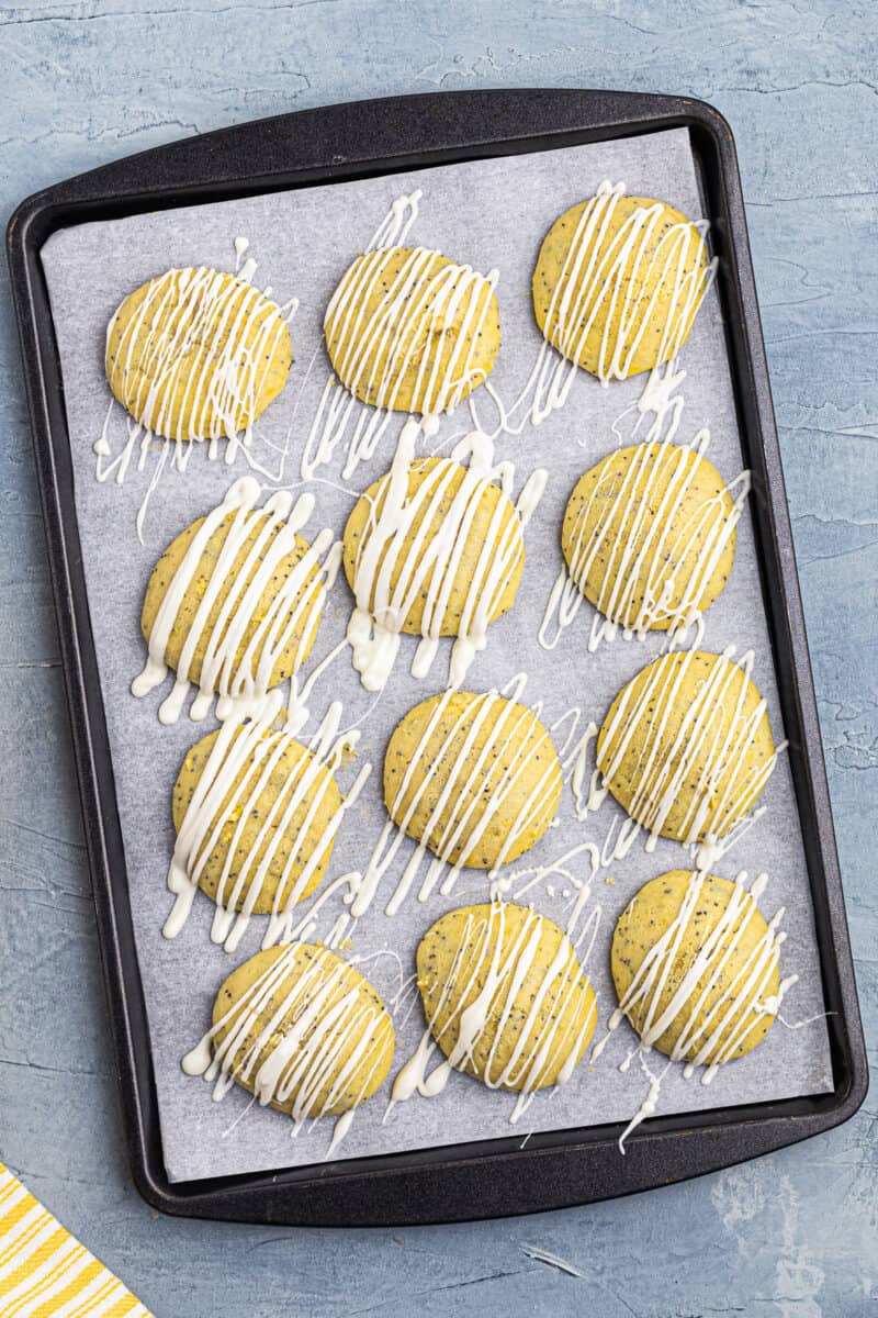 drizzled lemon poppy seed cookies on baking sheet