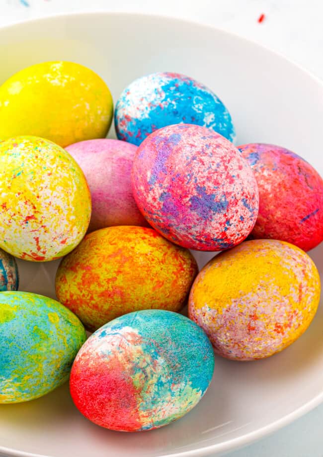 rice dyed easter eggs in many colors in bowl