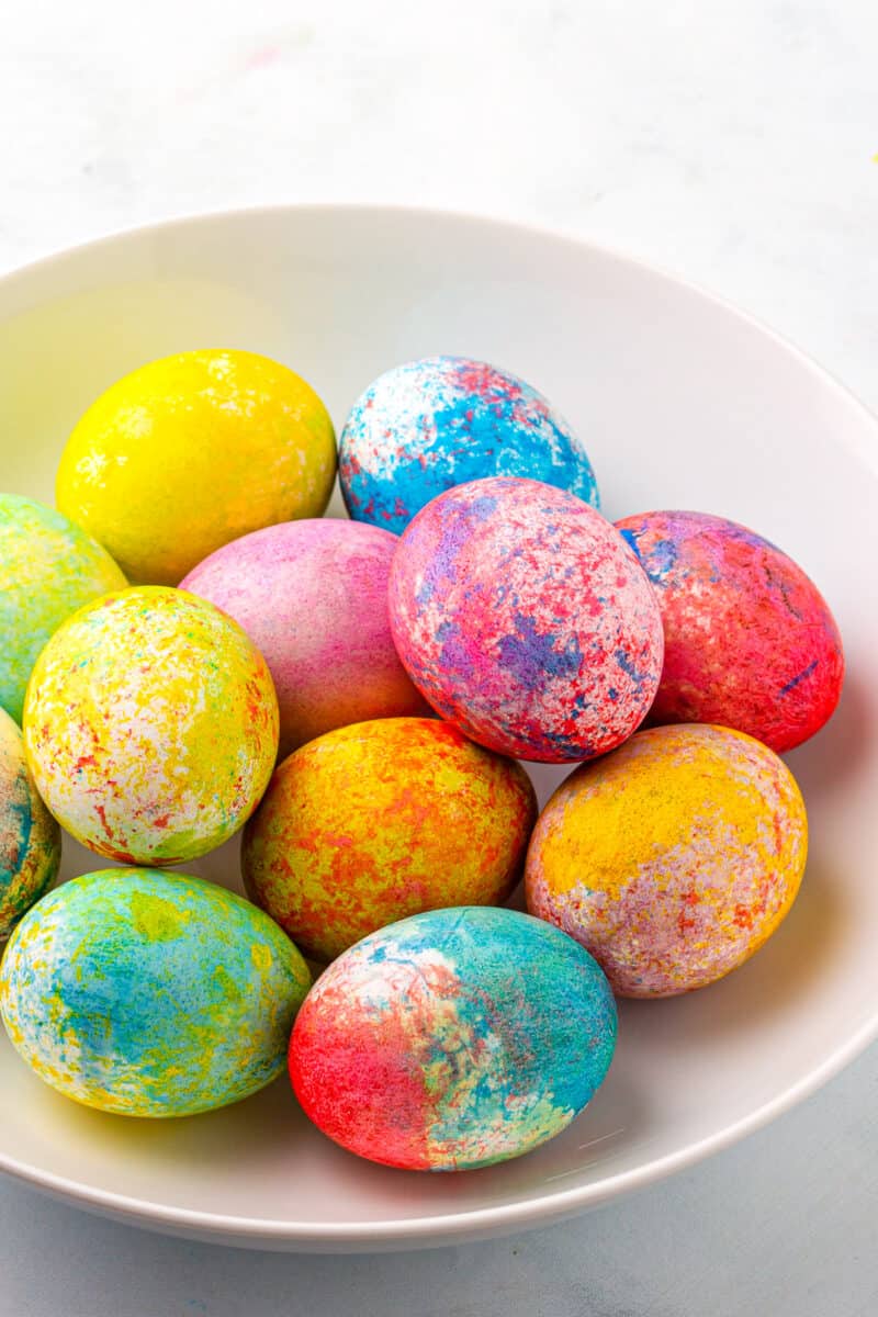 rice dyed easter eggs in many colors in bowl