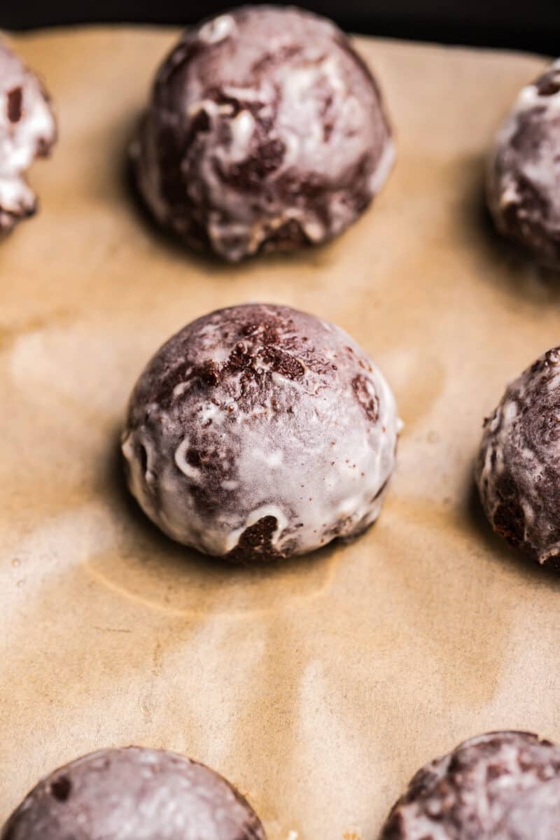 glazed chocolate donut holes made in an air fryer on parchment