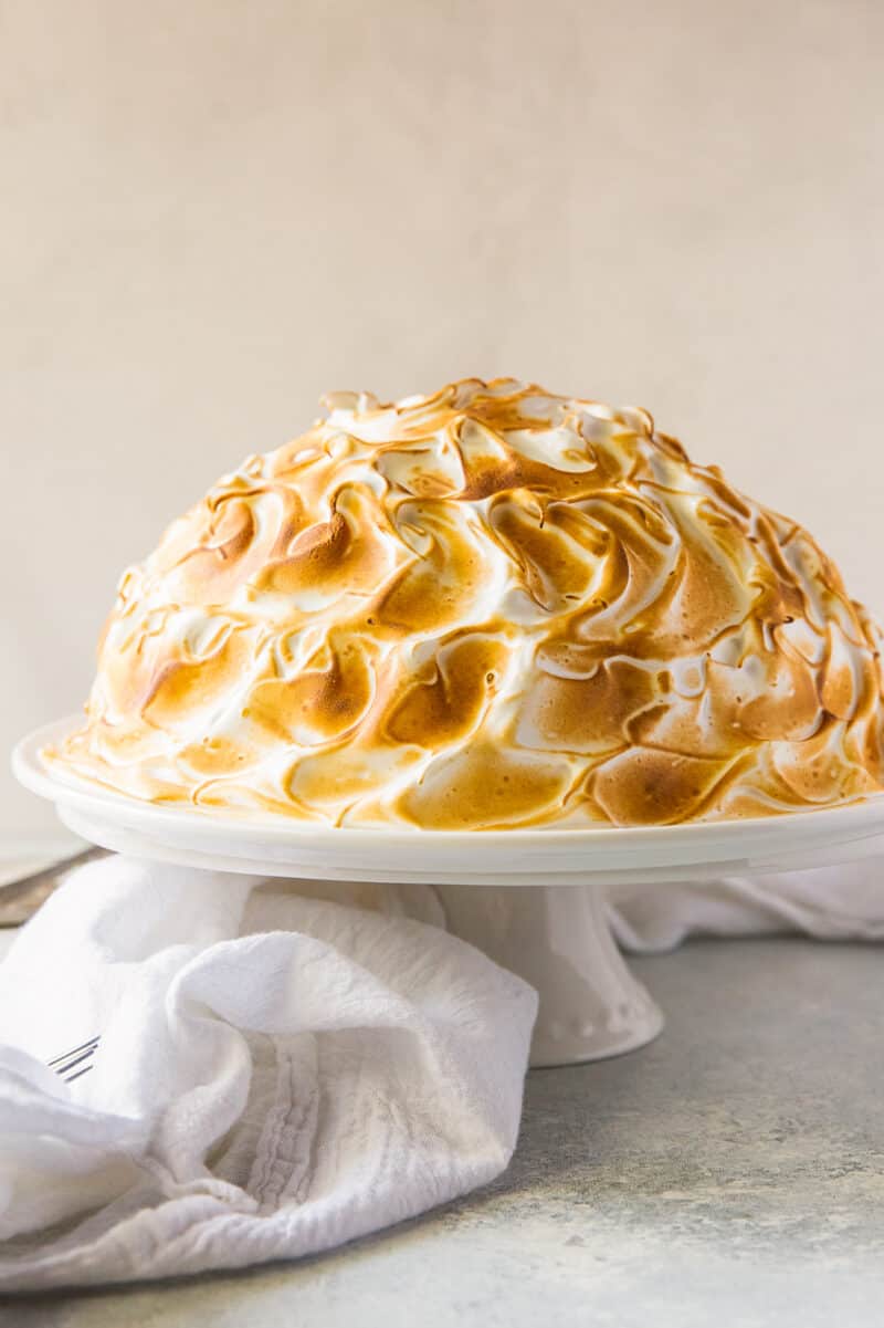 baked alaska with toasted meringue on cake stand