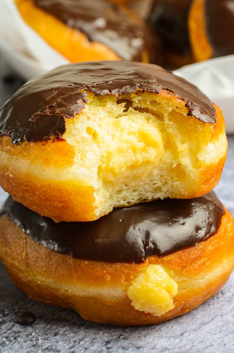 up close stacked boston cream donuts
