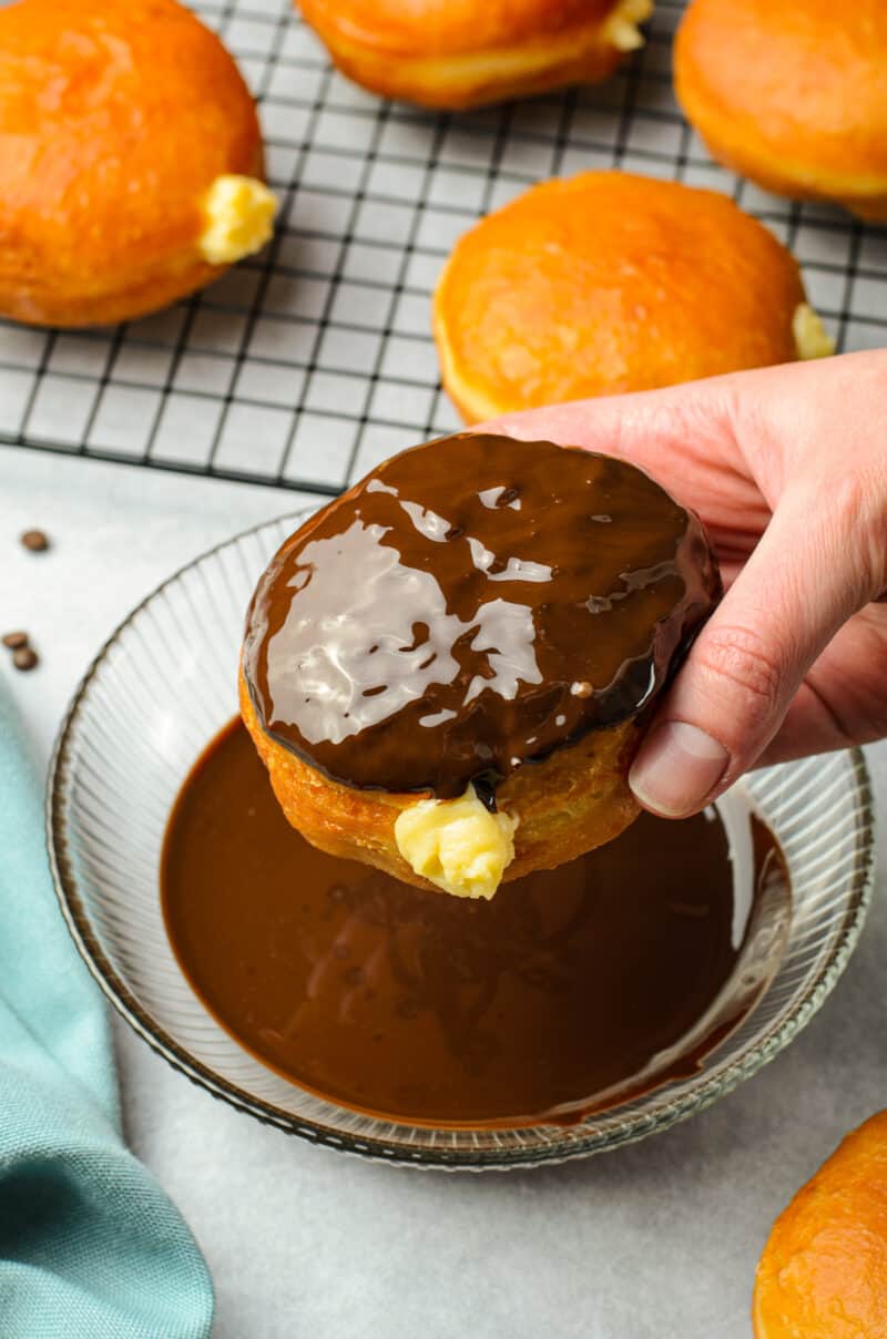 dipping boston cream donuts in chocolate