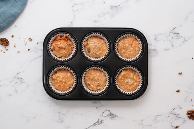 carrot cake cupcake batter in a cupcake tin.