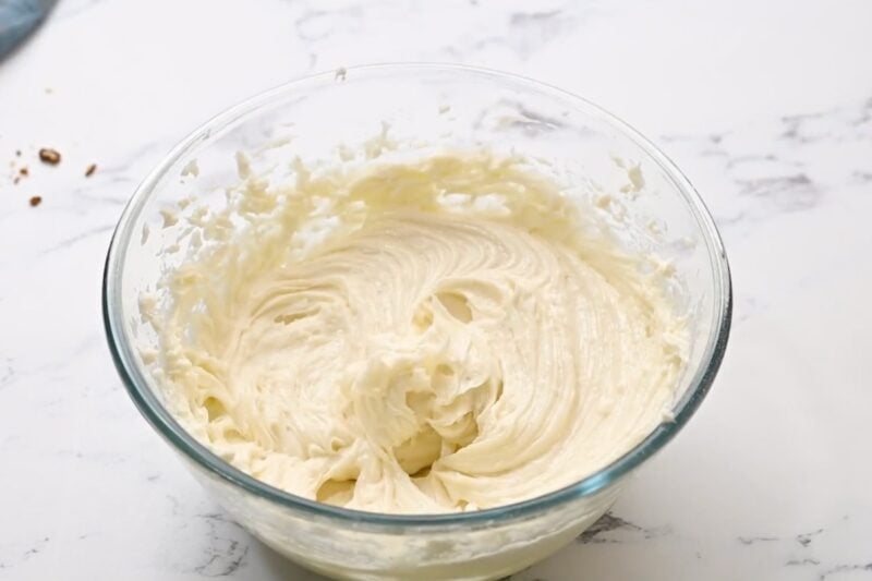 beaten cream cheese frosting in a glass bowl.