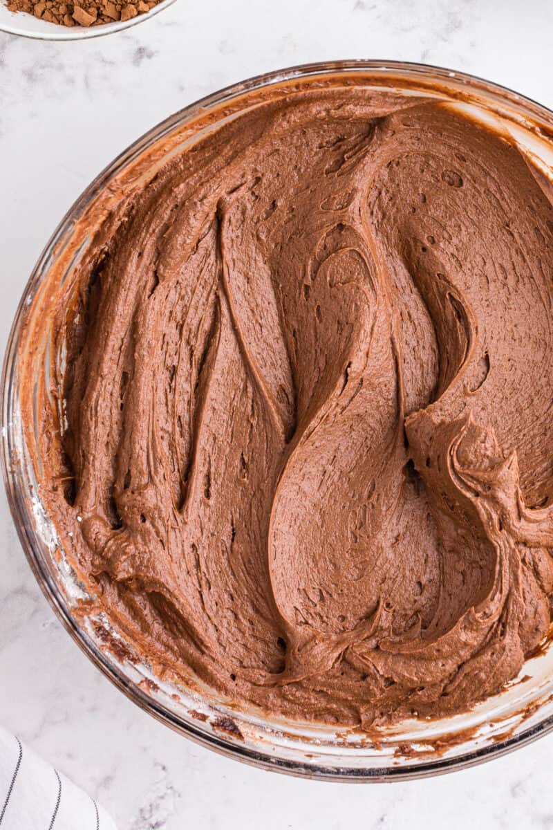 chocolate buttercream frosting in glass mixing bowl