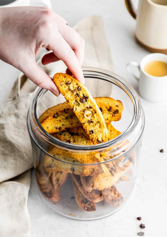 lifting chocolate chip biscotti out of glass jar