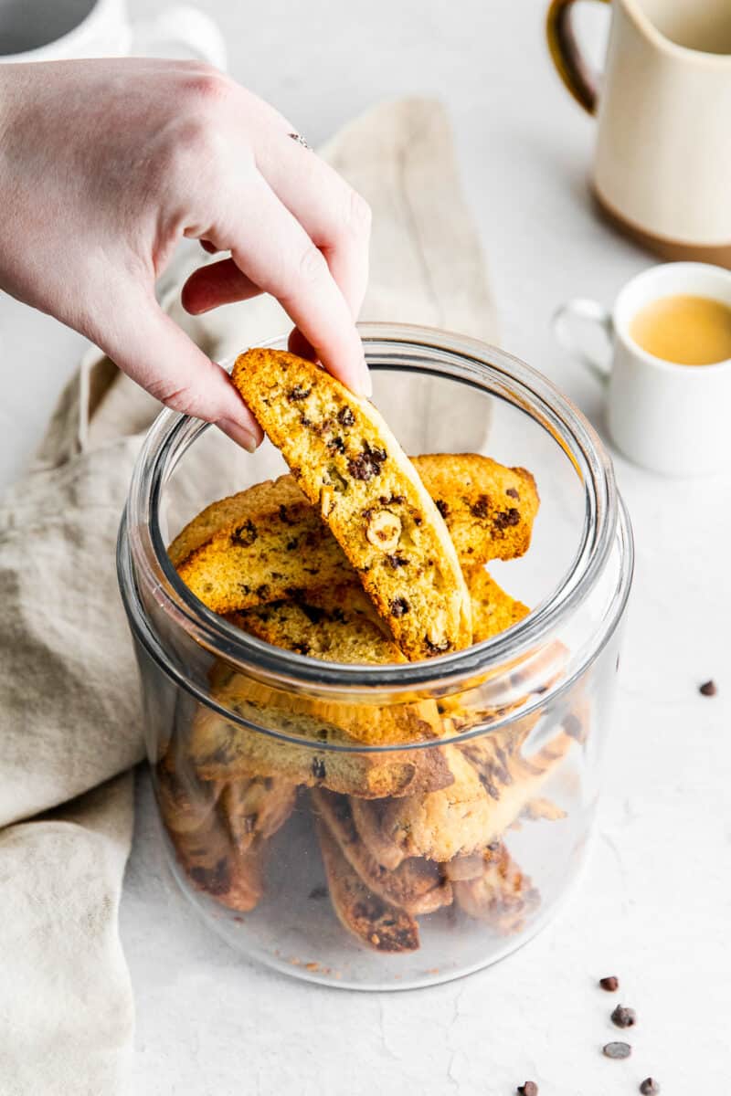 lifting chocolate chip biscotti out of glass jar