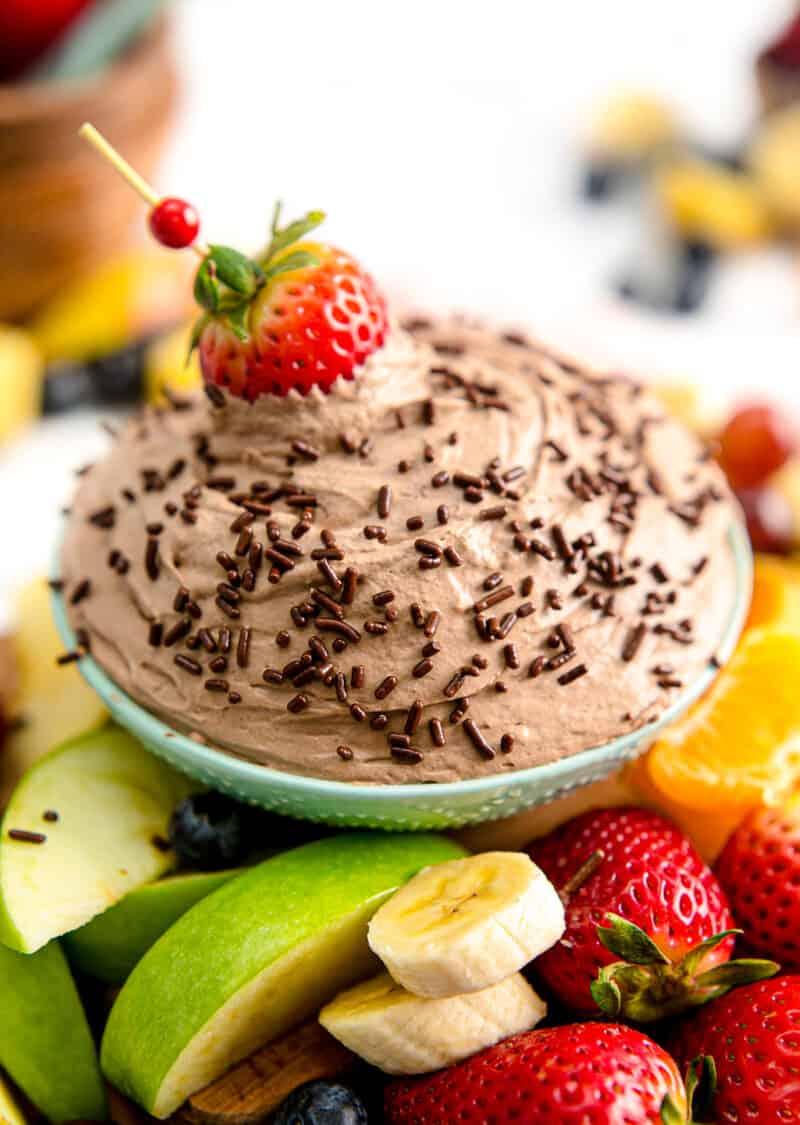 dipping a strawberry in chocolate fruit dip