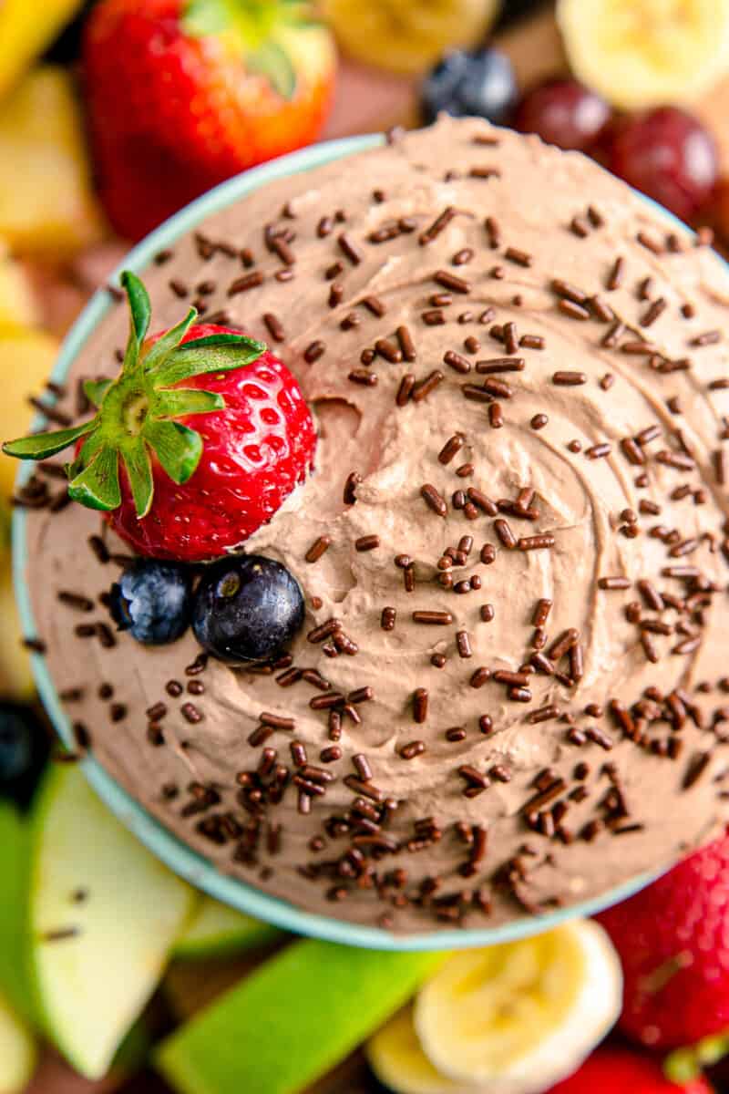 up close image of chocolate fruit dip with blueberries and strawberries
