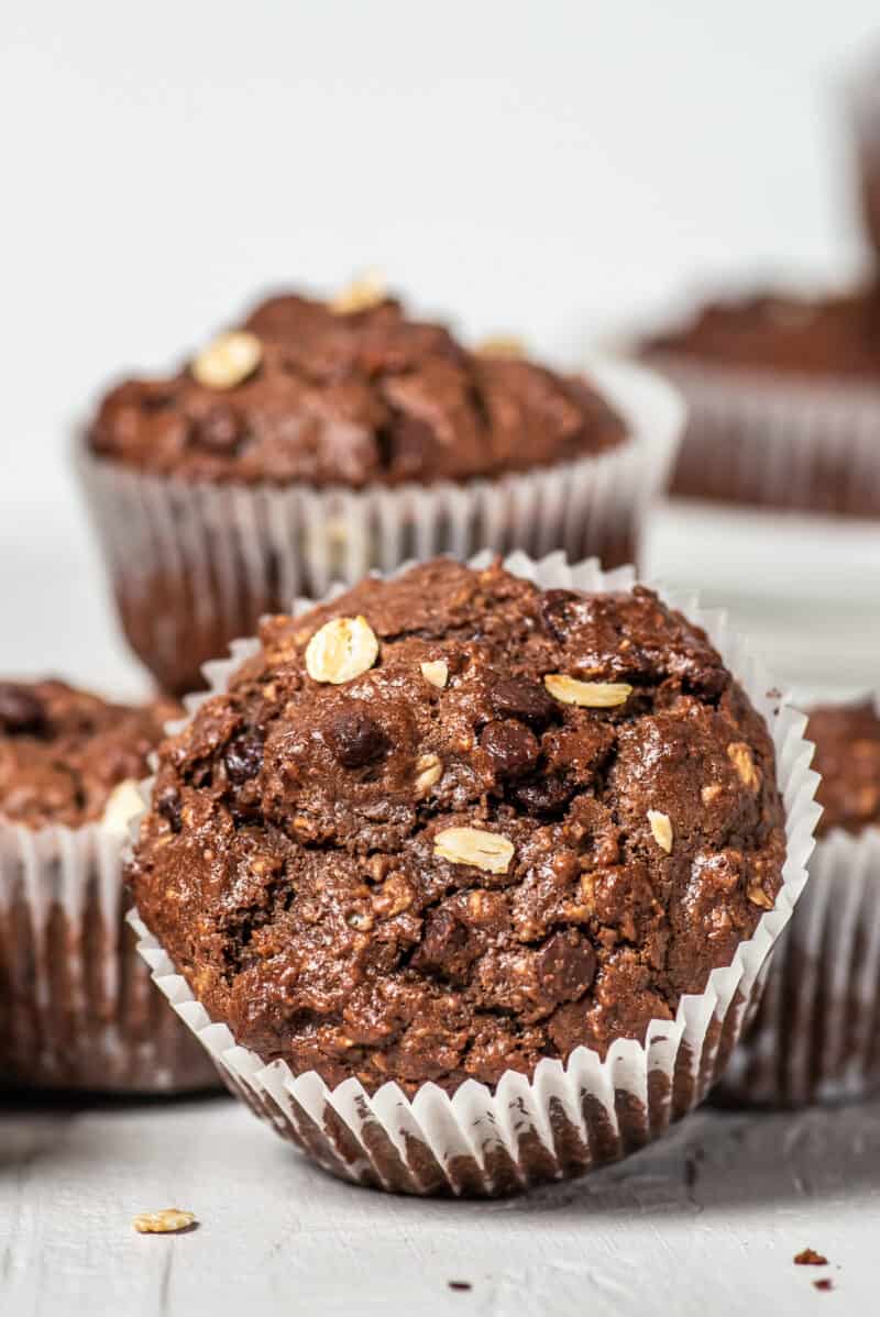 white table with chocolate oatmeal muffins