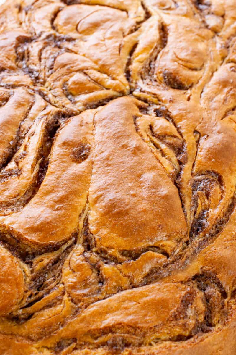up close image of swirled top of cinnamon roll cake