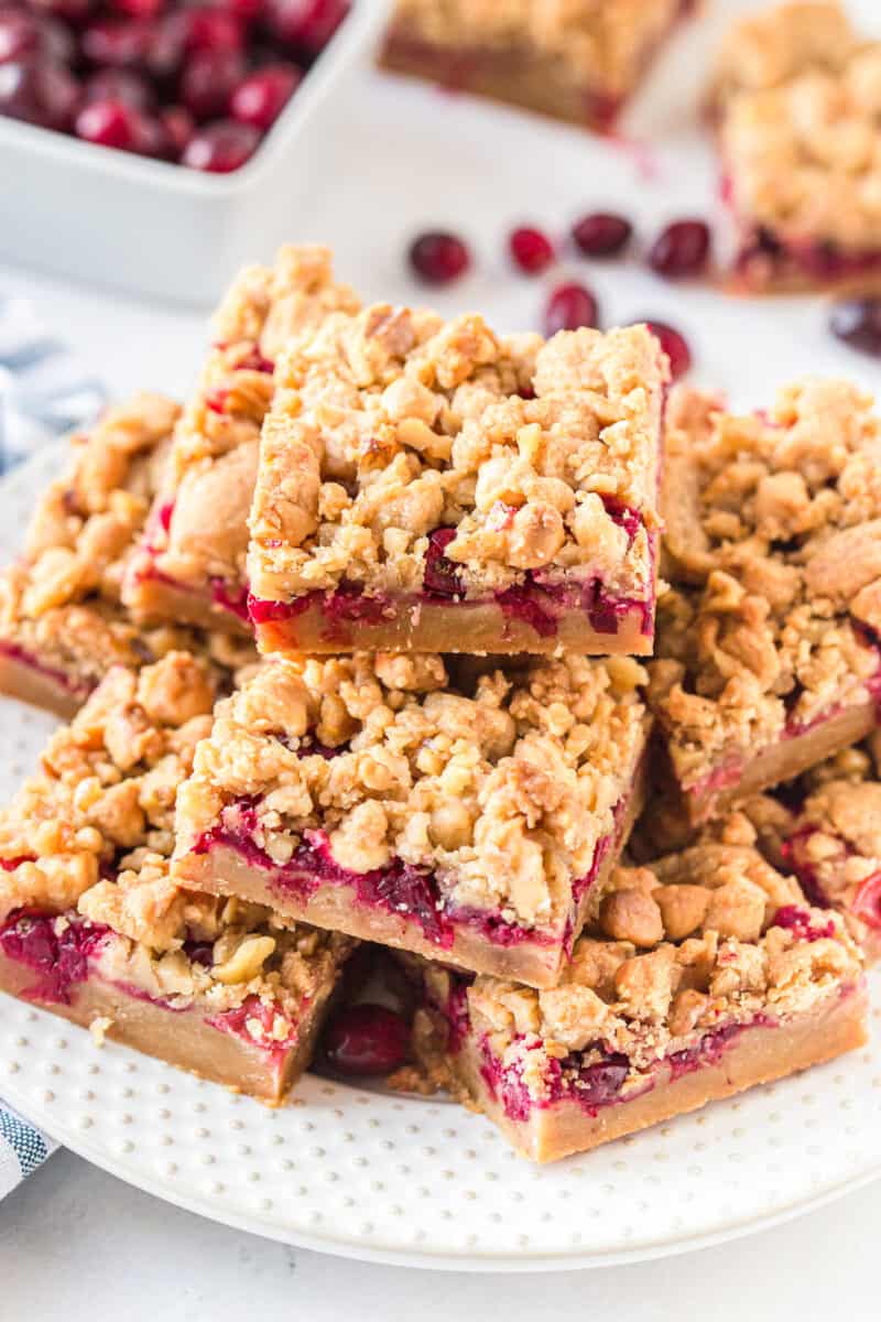 white plate with stacked cranberry crumble bars