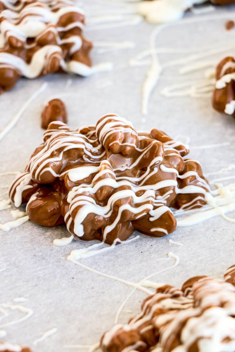 crockpot chocolate peanut candy drizzled with white chocolate
