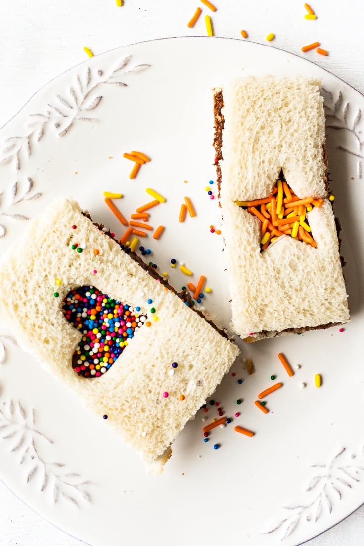 up close fairy bread with nutella cut outs on white plate