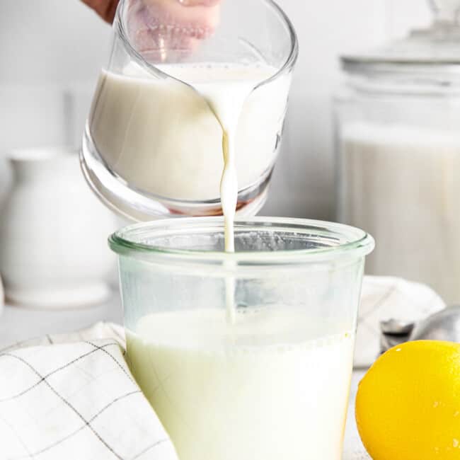pouring homemade buttermilk into jar