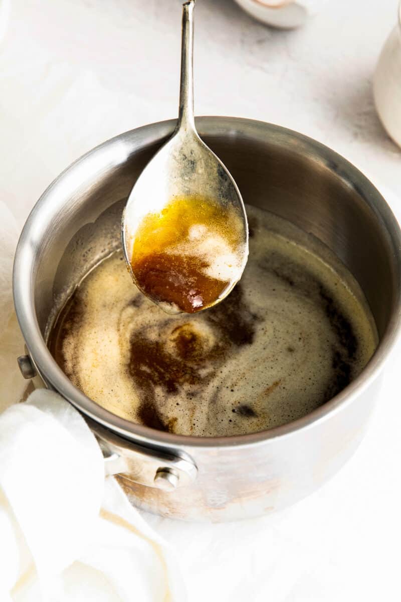 brown butter in saucepan with metal spoon