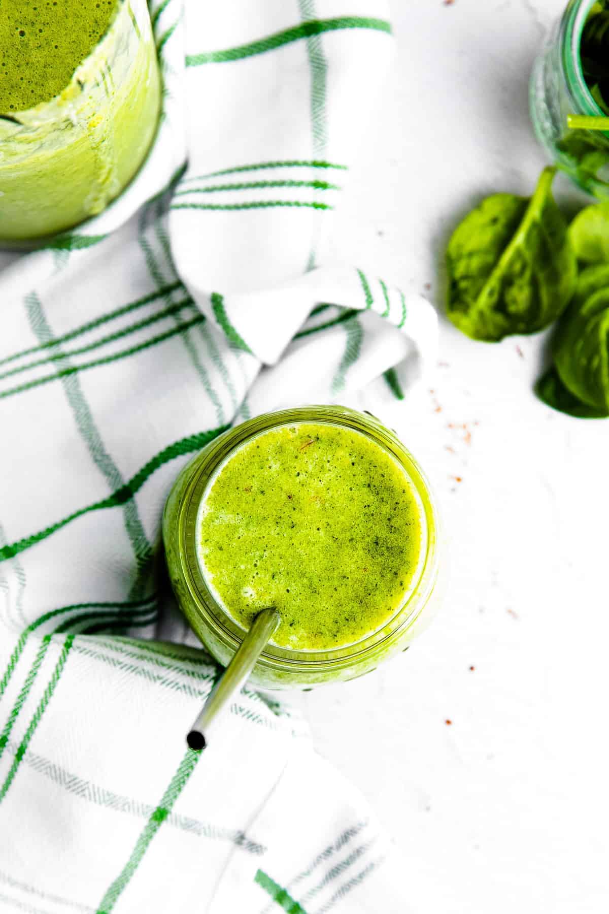 overhead island green smoothie with metal straw