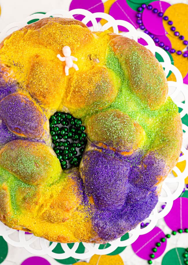 green yellow and purple king cake with baby