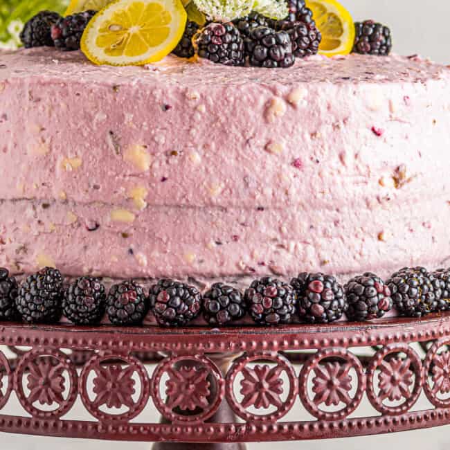 lemon blackberry cake on cake stand