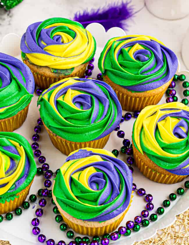 purple yellow and green king cake mardi gras cupcakes on platter