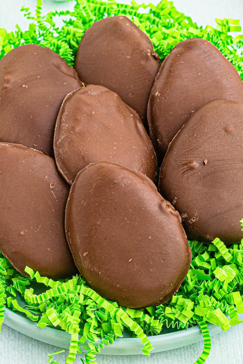 up close homemade reese's peanut butter eggs over fake grass