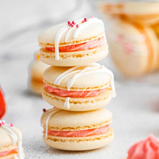 stacked strawberry macarons on white table