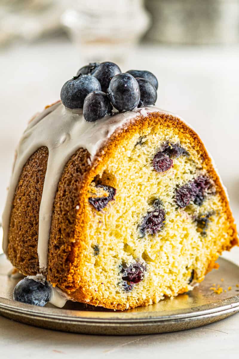 up close slice of fresh blueberry bundt cake with glaze
