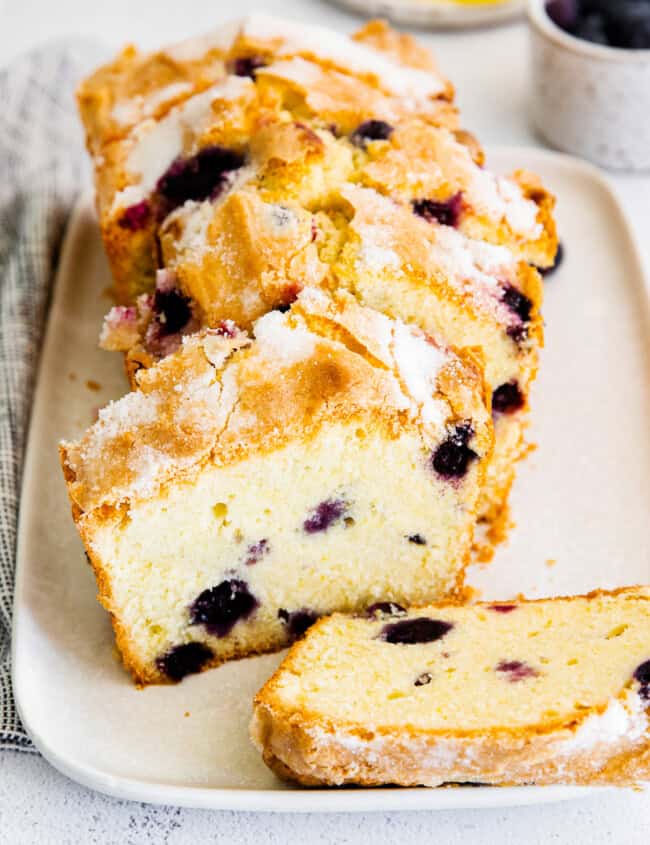 sliced blueberry lemon pound cake on white platter