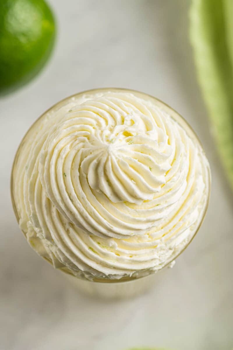 lime buttercream piped into glass cup