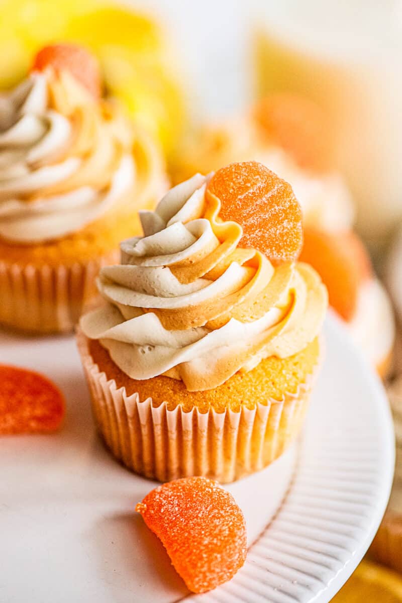 orange creamsicle cupcakes on cake stand