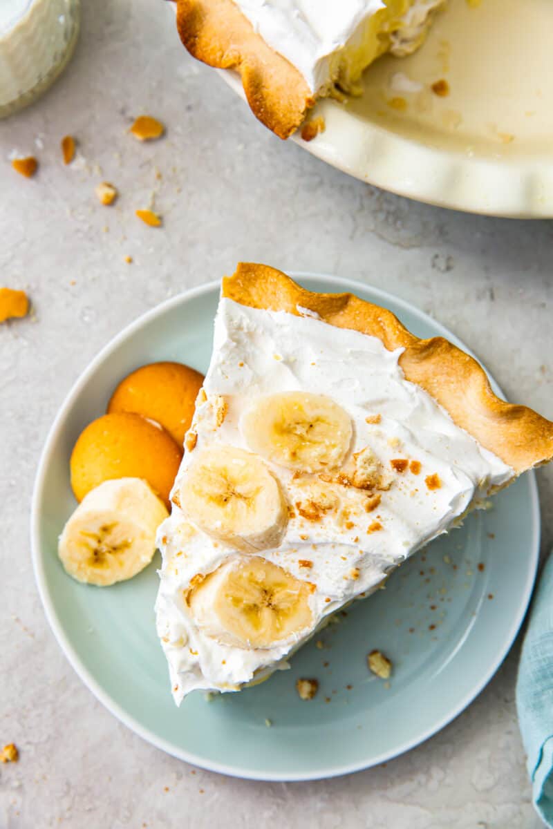 overhead slice of banana cream pie on blue plate