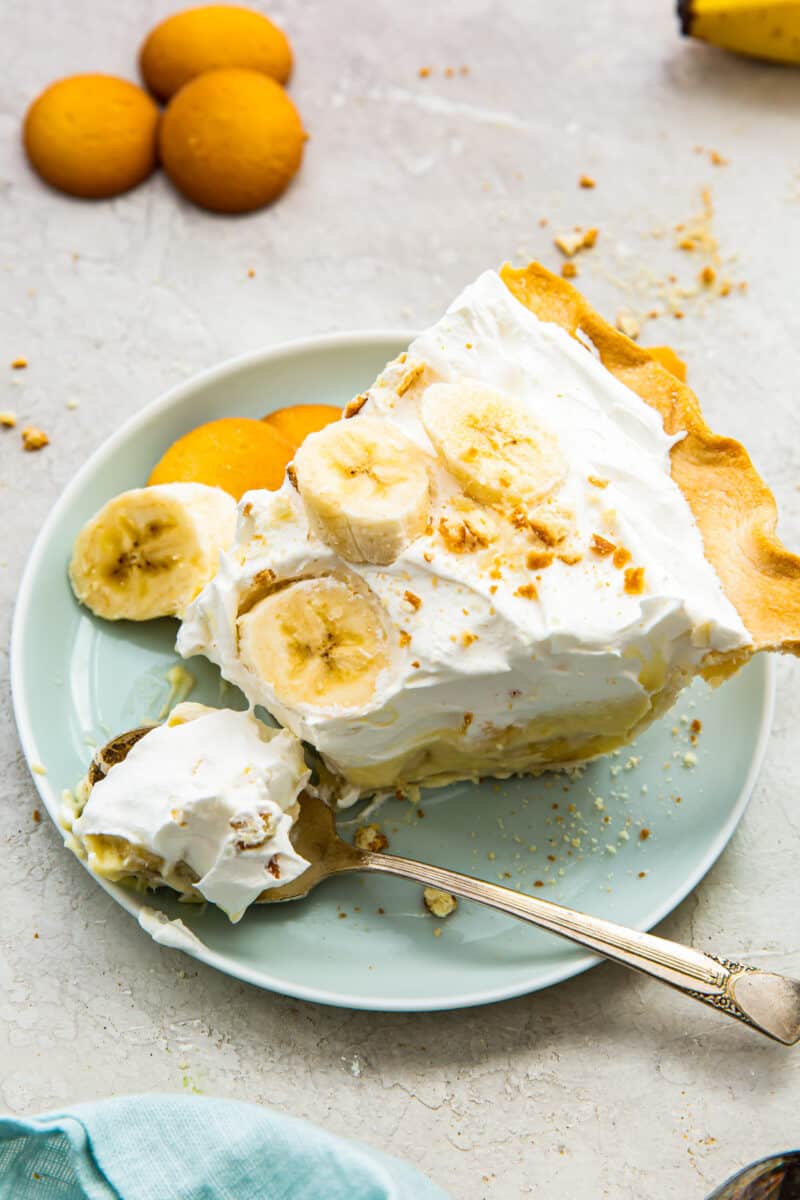 overhead slice of banana cream pie on blue plate