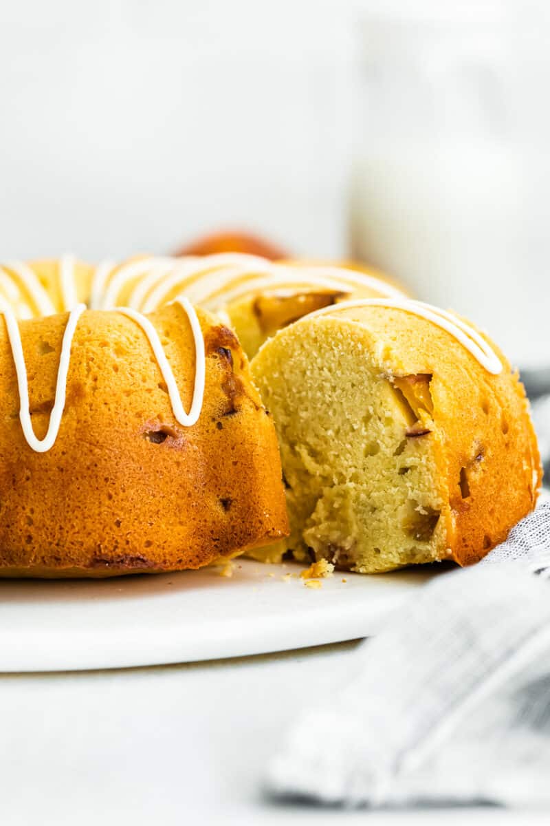 side image of slice being taken out of peach bundt cake