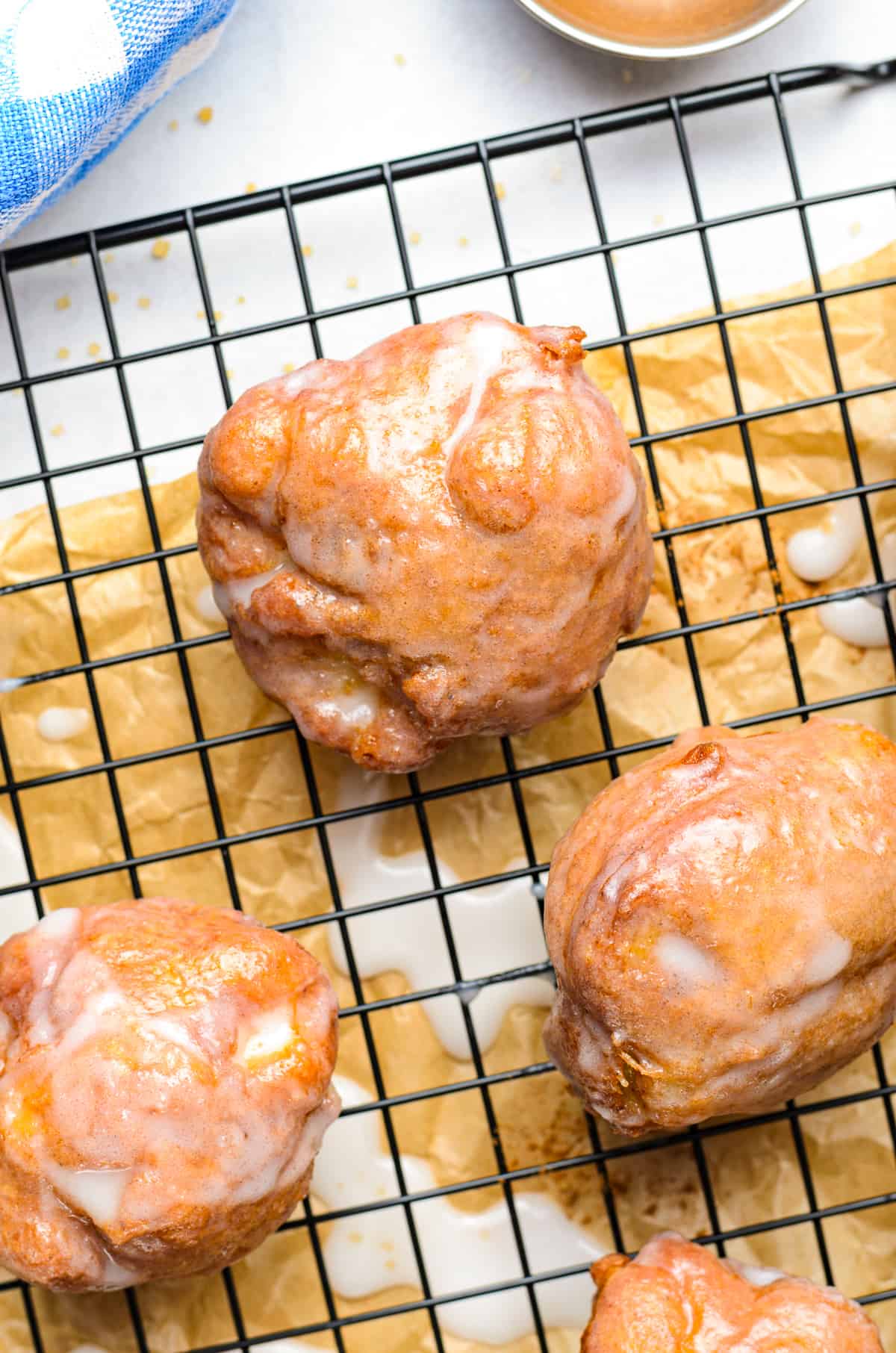 fried apple fritters on cooling rack