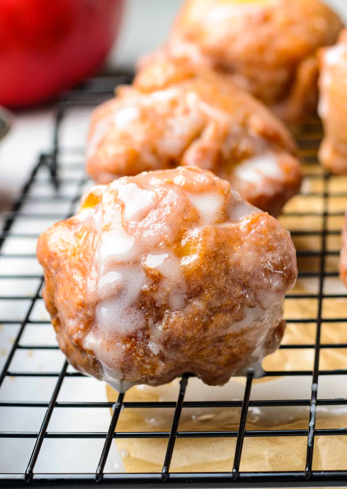 glazed fried apple fritters on cooling rack