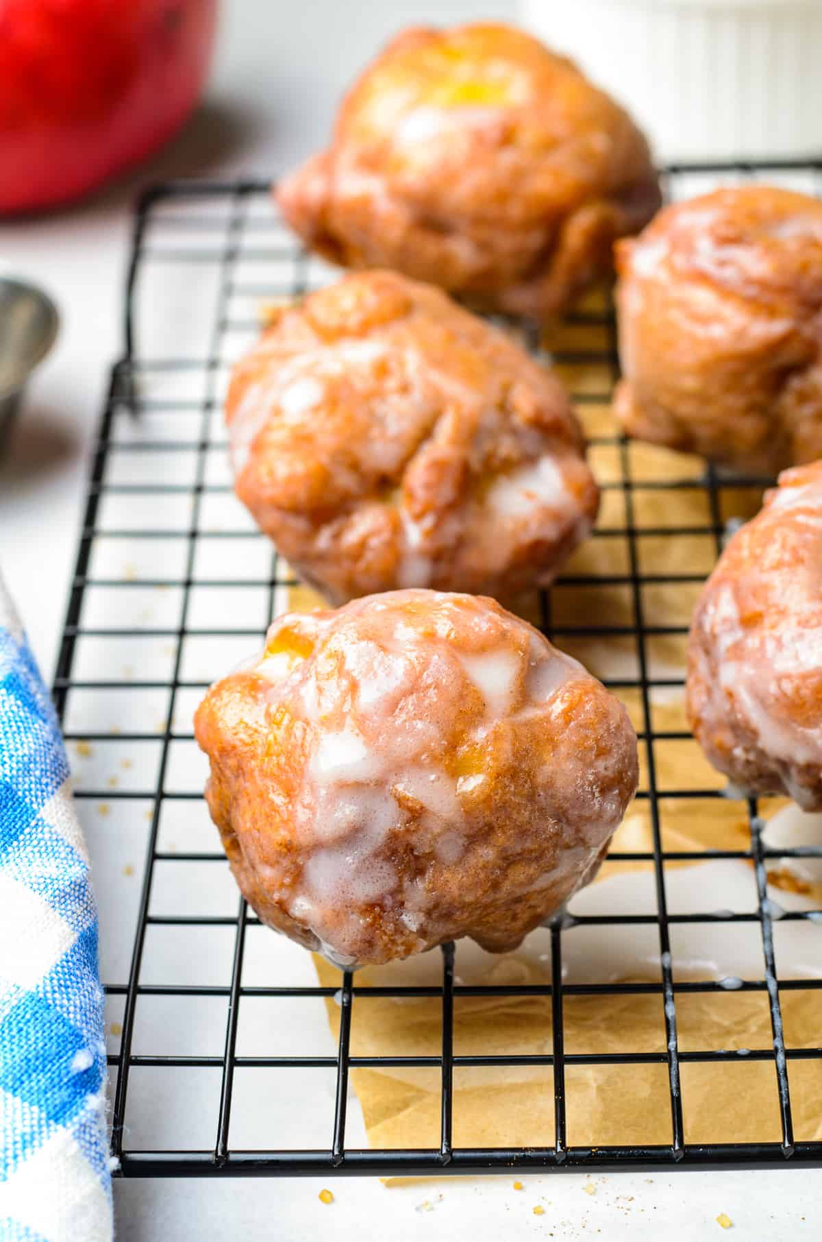 glazed fried apple fritters on cooling rack