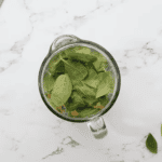 tropical green smoothie ingredients in a blender.