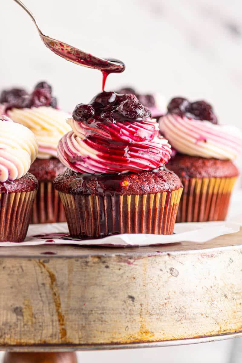 topping red velvet cupcakes with blueberry compote