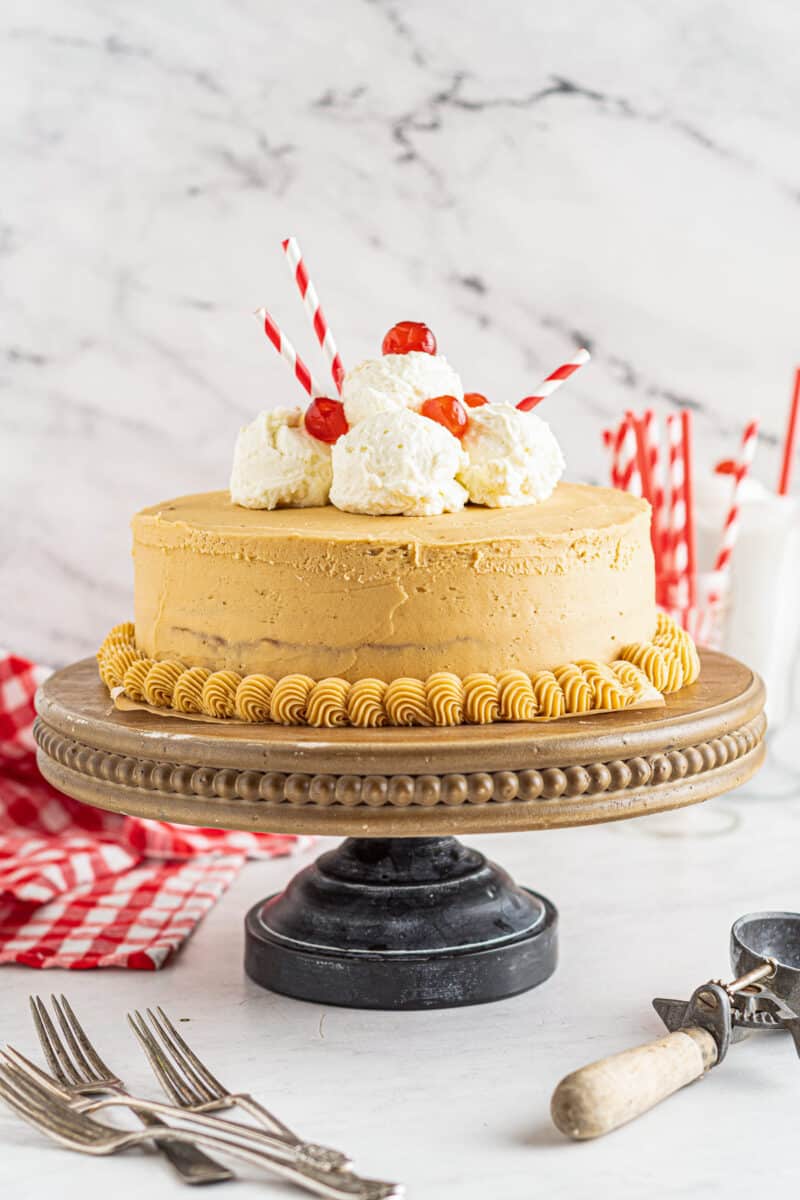 root beer float layer cake on cake stand