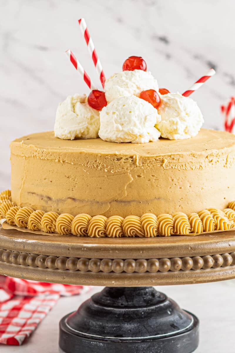 up close root beer float layer cake on cake stand