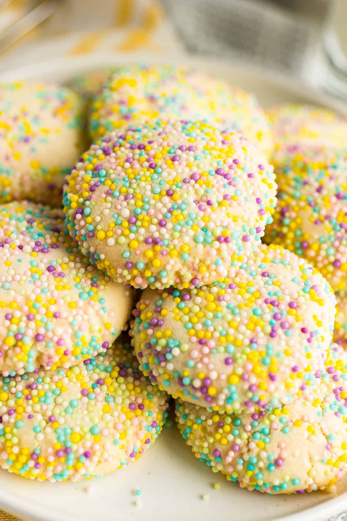 stacked sprinkle cookies on white plate