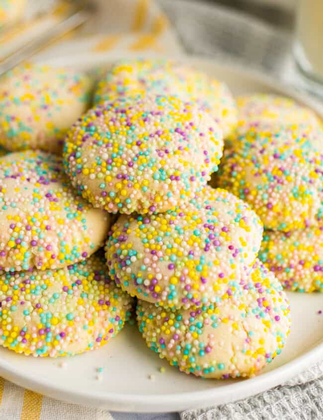 stacked sprinkle cookies on white plate